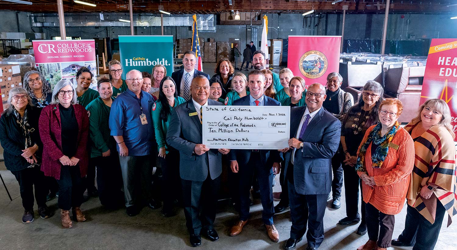(FRONT ROW) Senate Majority Leader Mike McGuire (CENTER) joins College of the Redwoods President Keith Flamer (RIGHT) and Cal Poly Humboldt President Tom Jackson, Jr. (LEFT) to celebrate the $10 million investment to transform a warehouse on Samoa Boulevard
in Arcata into a state-of-the-art learning lab.