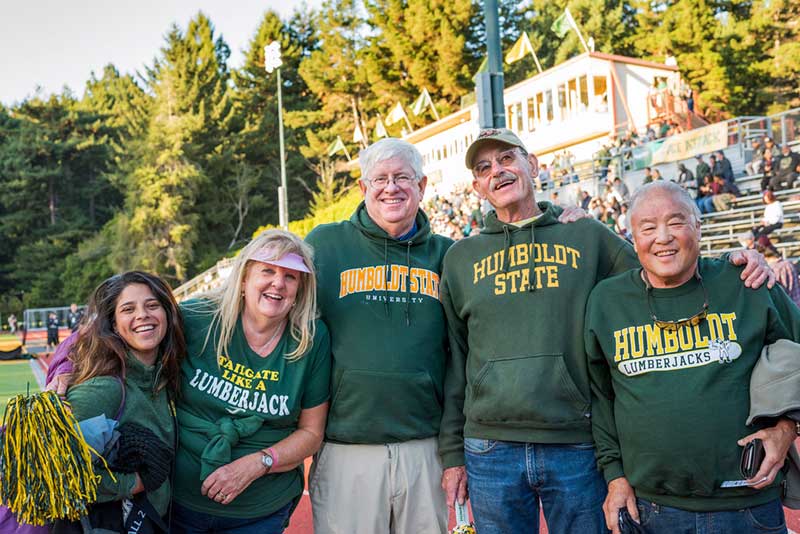 From left to right: Vanessa Gonsalves, former Humboldt Alumni Outreach Coordinator at Cal Poly Humboldt, Cathy Flores, Craig Tucker, Kevin Dempsey, and Randy Ishihara sporting their Humboldt gear at the Redwood Bowl.
