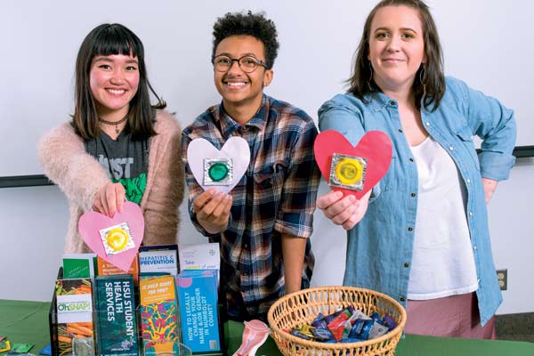 three students offering contraception